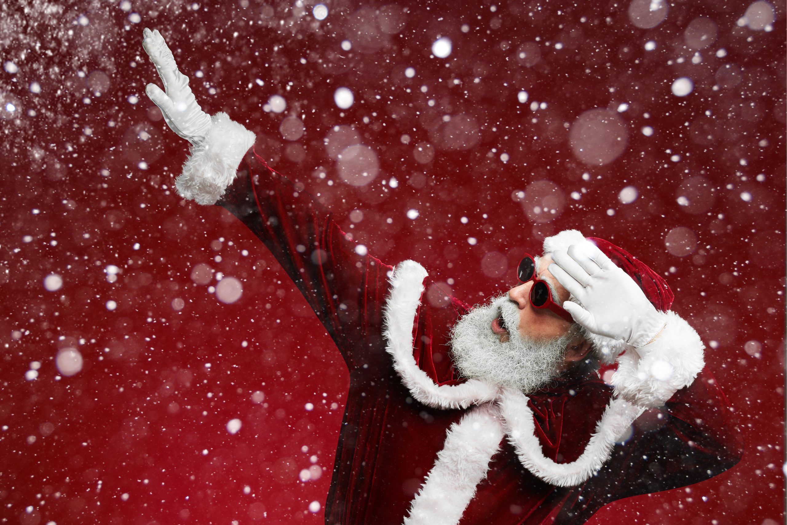 Waist up portrait of funky Santa dancing over red background with snow falling
