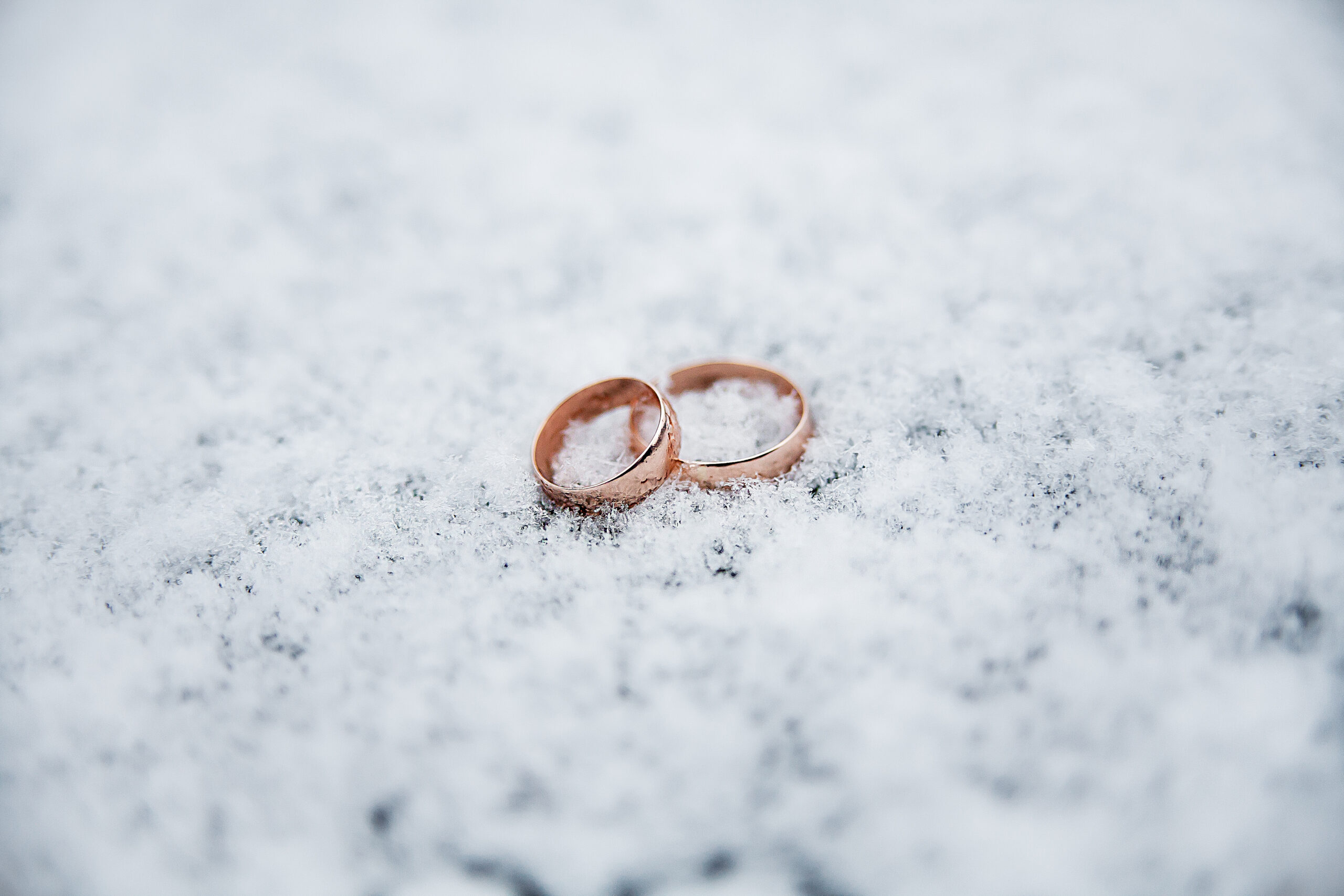 wedding rings placed in the snow
